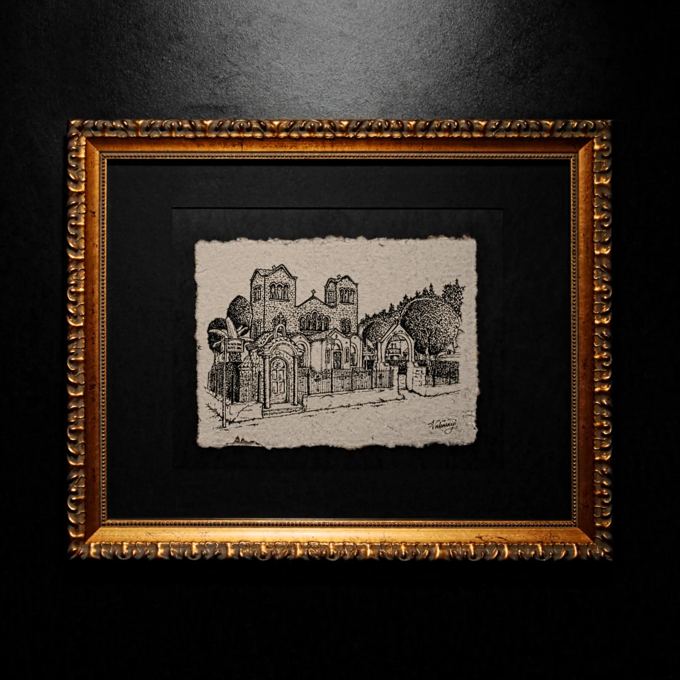 A black ink architectural drawing of a classical building with two towers, created on textured handmade paper with deckled edges, set within a black mat and a gold ornate frame.