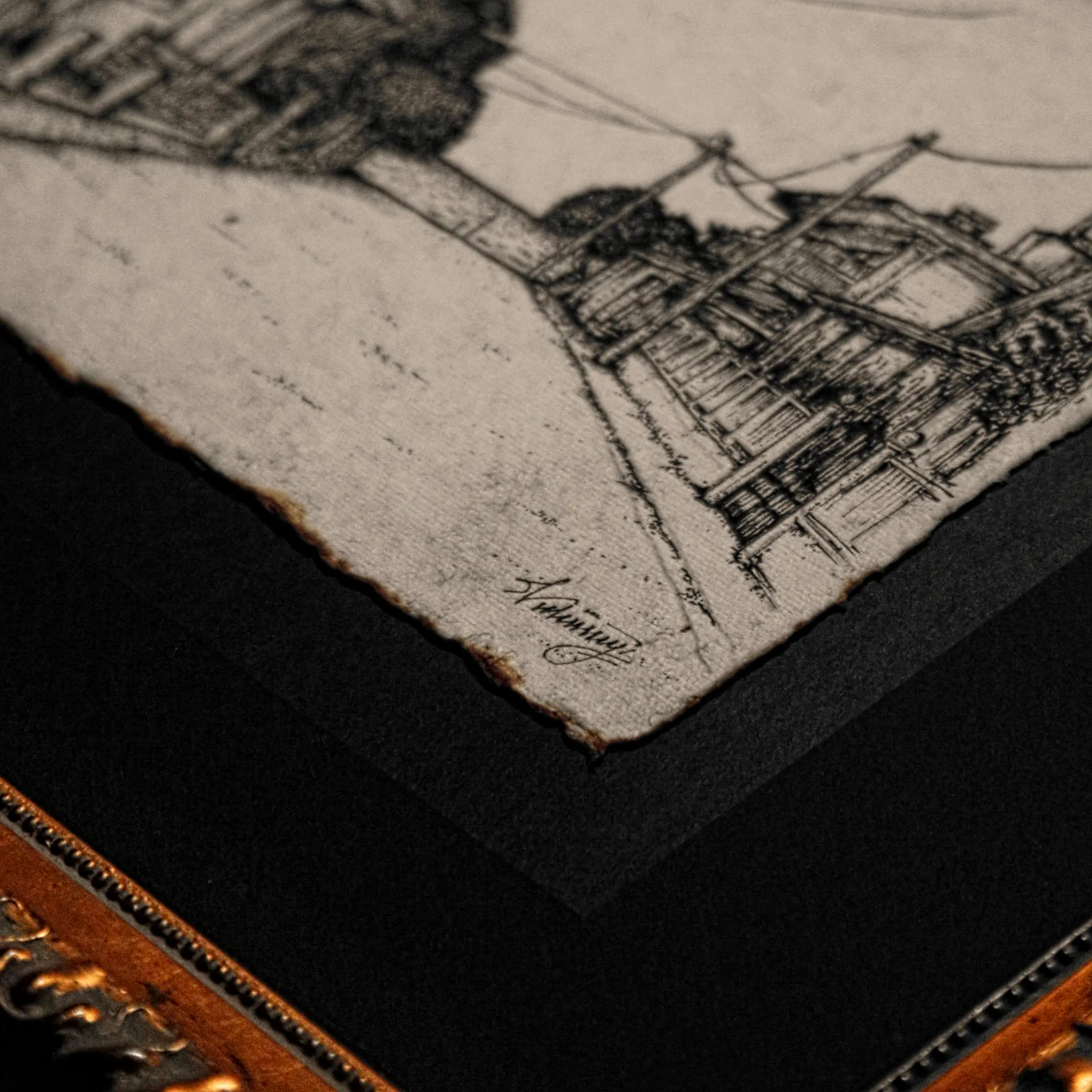 Close-up of artist Vselenskyi's signature on an ink drawing with deckled edges, matted in black and set in a gilded frame.