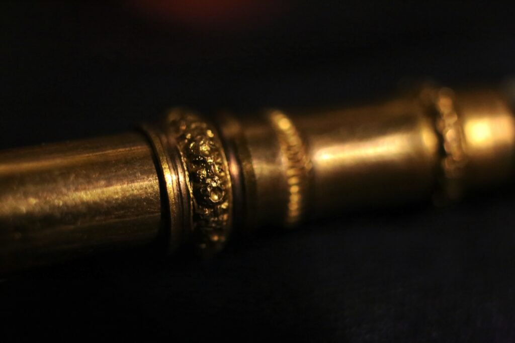 Macro close-up of a detailed decorative ring on the gold section of an antique ink pen.